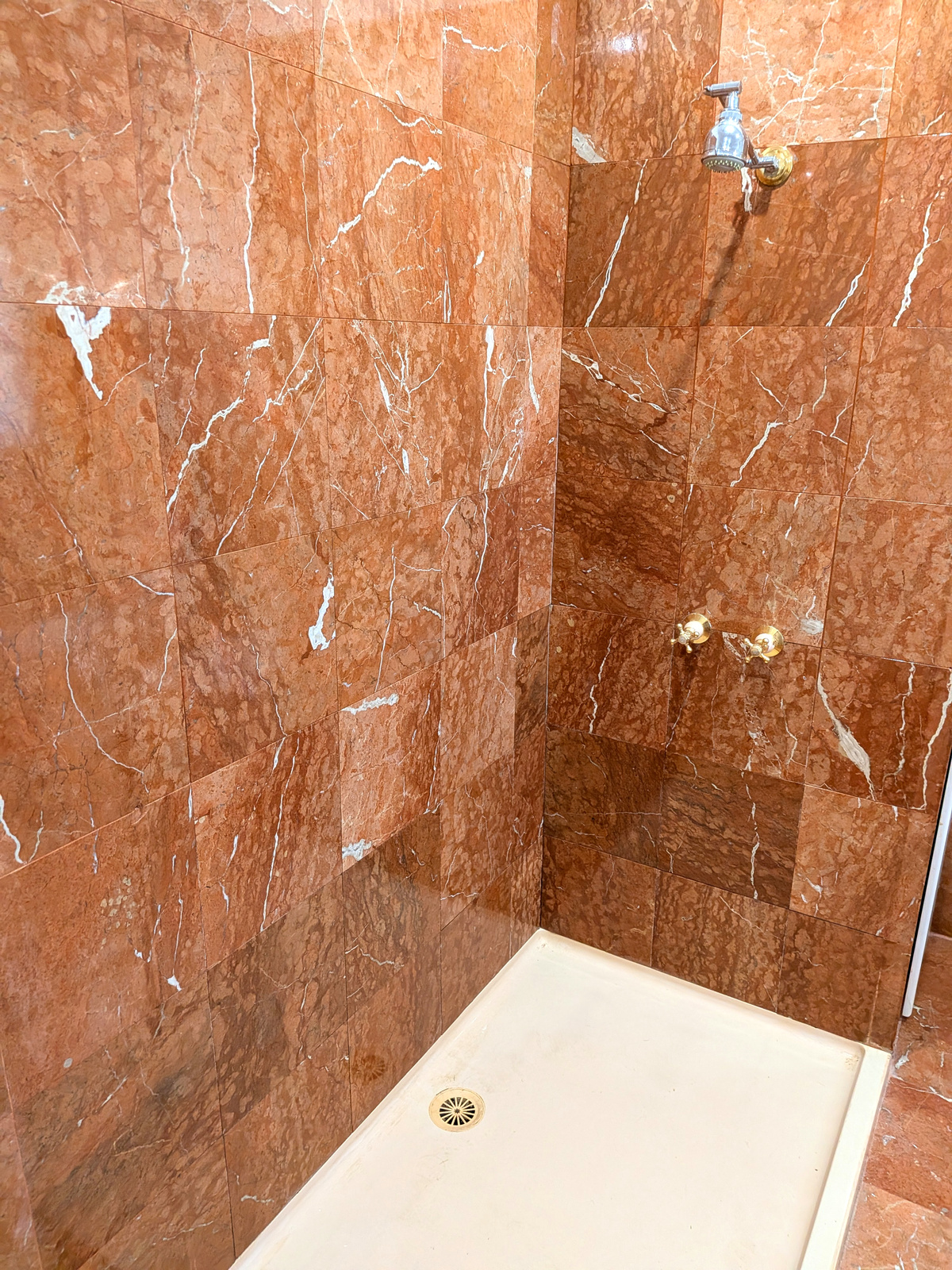 After — red marble shower polished