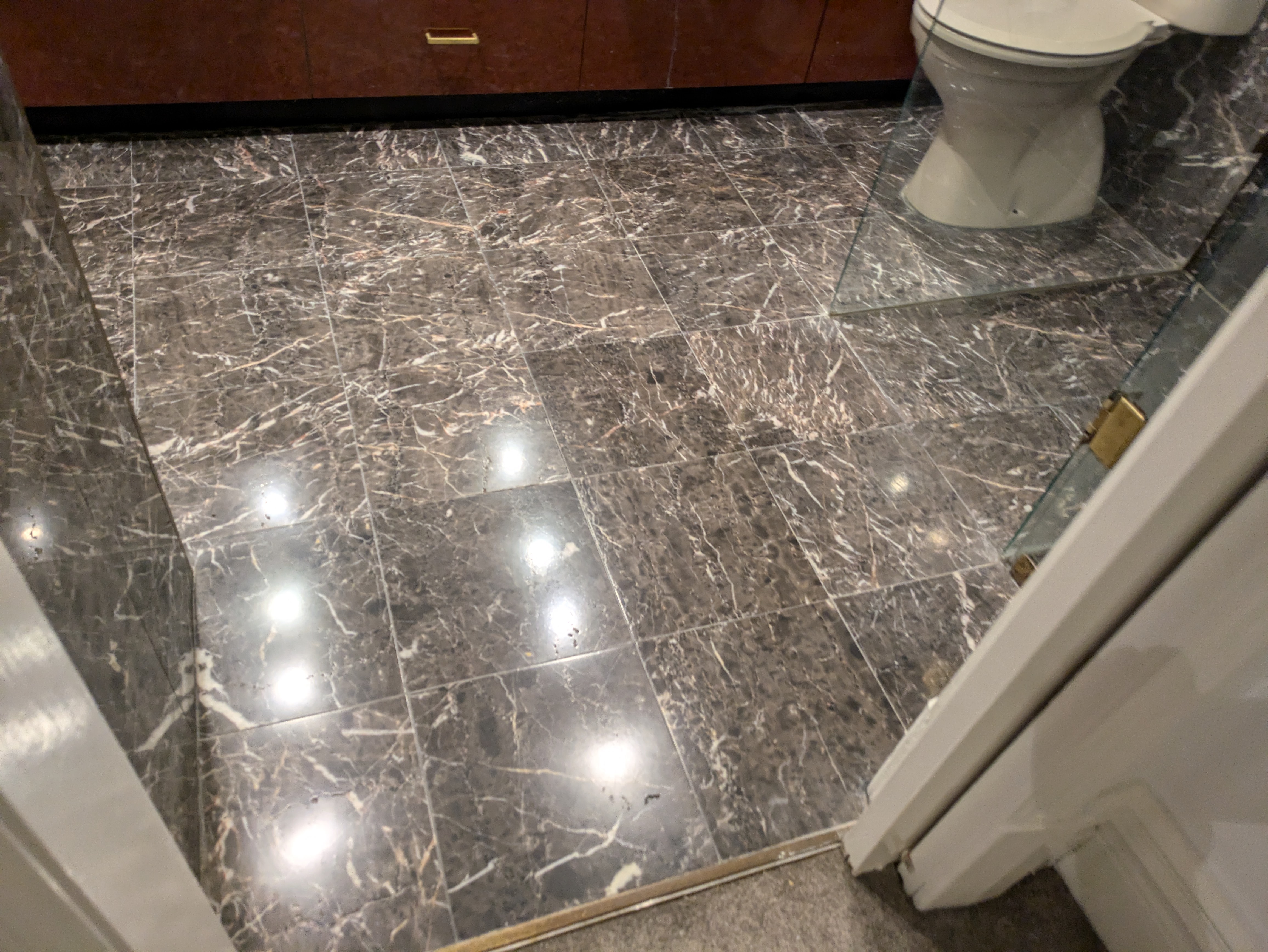 Dark marble bathroom floor polished